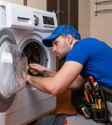 Professional technician repairing washing machine with diagnostic tools in Cape Town
